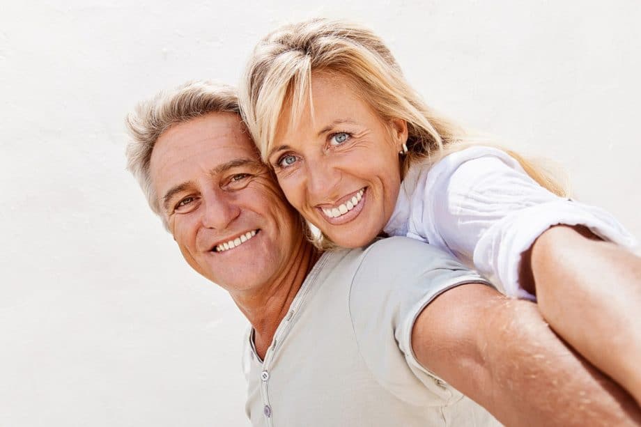 a couple with veneers smiles and embraces